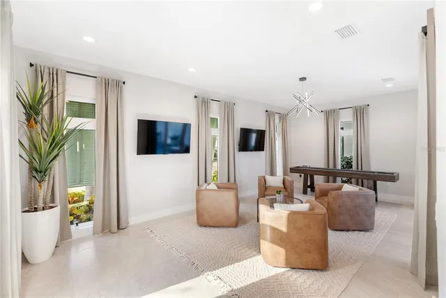 a kitchen with stainless steel appliances a stove a sink a dining table and chairs