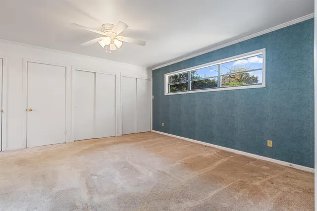 a view of an empty room with a fan