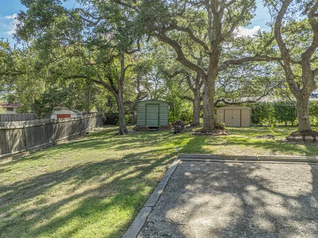 a view of a house with a yard and tree