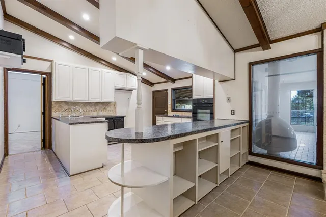 a kitchen with stainless steel appliances granite countertop a sink and cabinets
