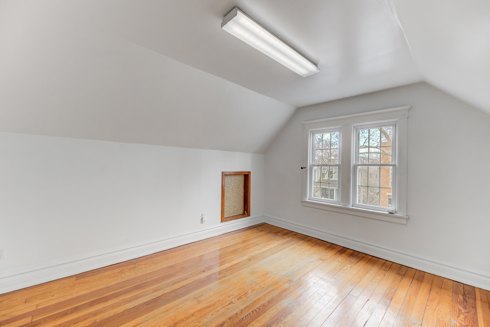 4018 North Whipple Street Chicago, IL 60618 - Photo 16 of 25 an empty room with wooden floor and windows