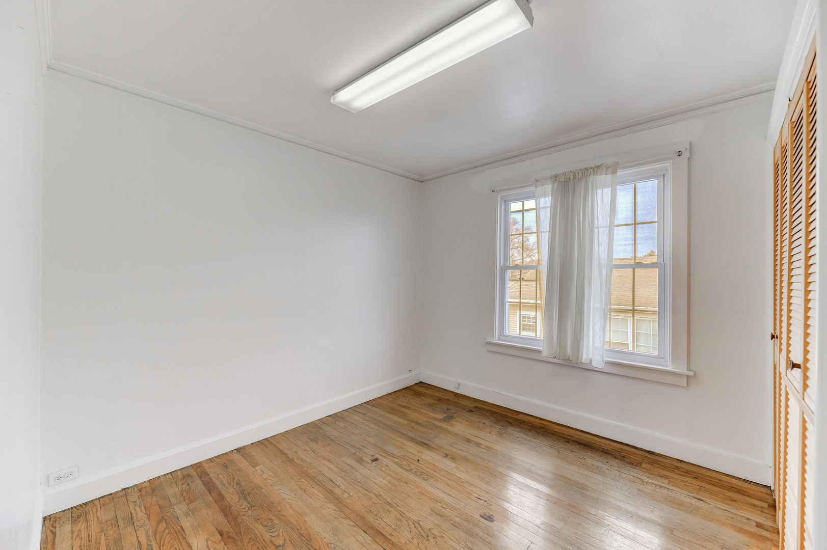 4018 North Whipple Street Chicago, IL 60618 - Photo 19 of 25 an empty room with wooden floor and windows