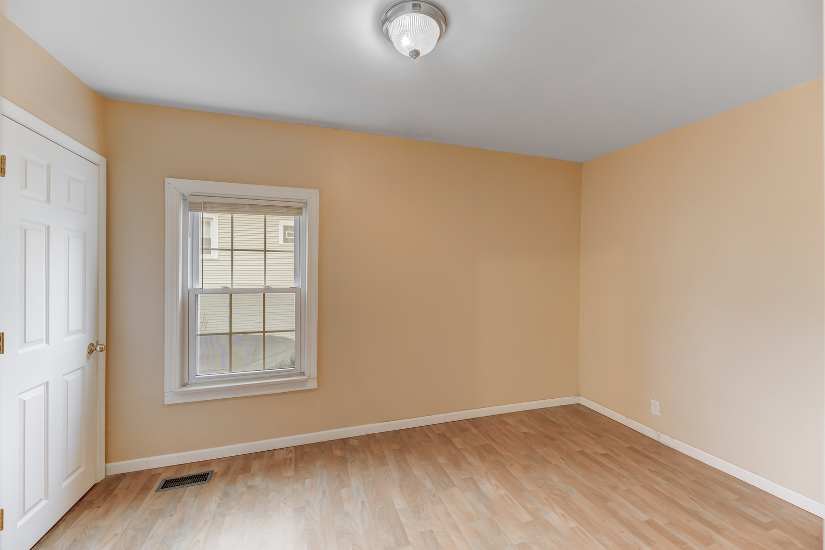 4018 North Whipple Street Chicago, IL 60618 - Photo 8 of 25 an empty room with wooden floor and windows