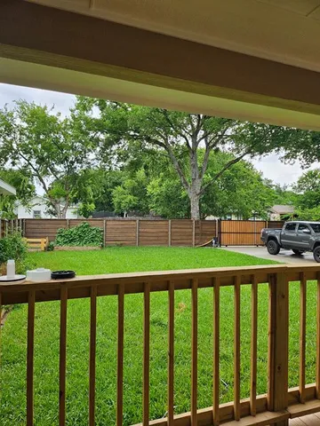 a view of a balcony with a yard