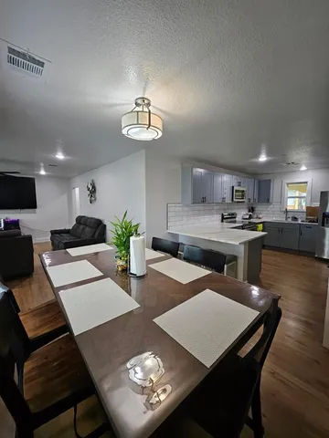 a view of a dining room with furniture and wooden floor