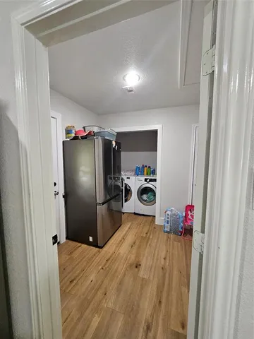 a kitchen with a refrigerator and a sink
