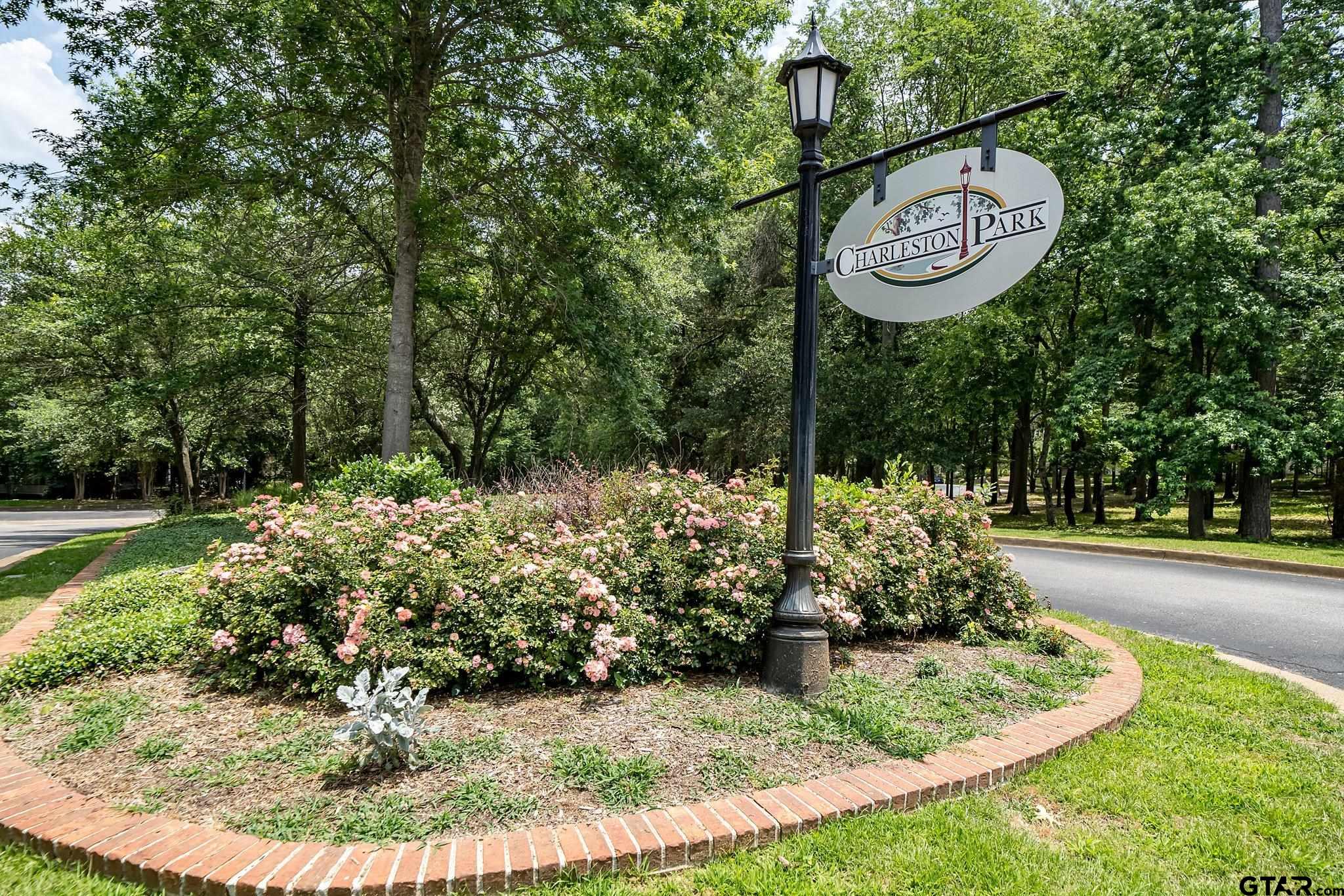 a view of a park with iron fence