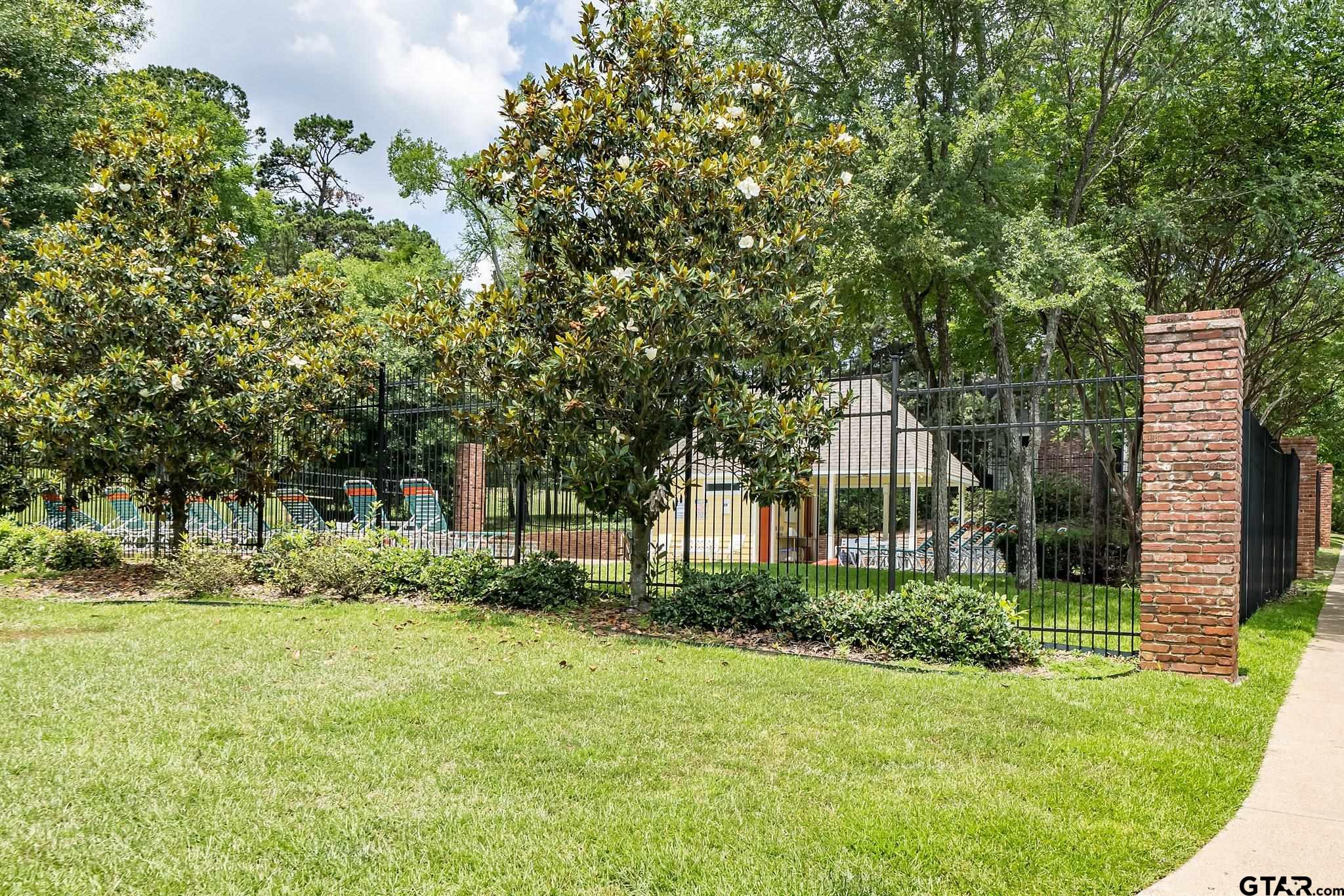 4028 Hanover Place Tyler, TX 75701 - Photo 4 of 16 a front view of a house with a yard