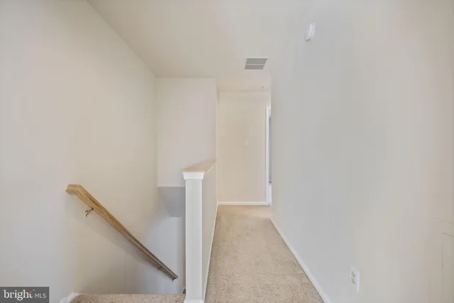 a bathroom with a granite countertop toilet and a sink