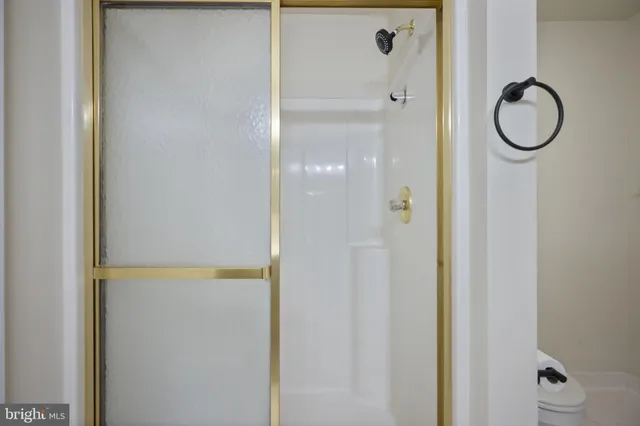 a bathroom with a sink toilet vanity and shower
