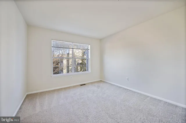 a view of empty room with a fireplace
