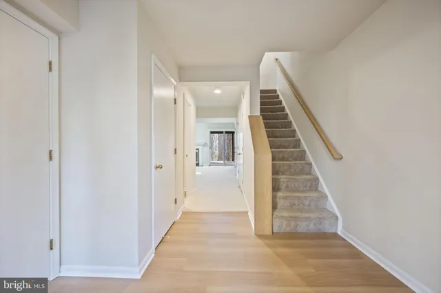 a kitchen with stove a sink and dishwasher with wooden floor