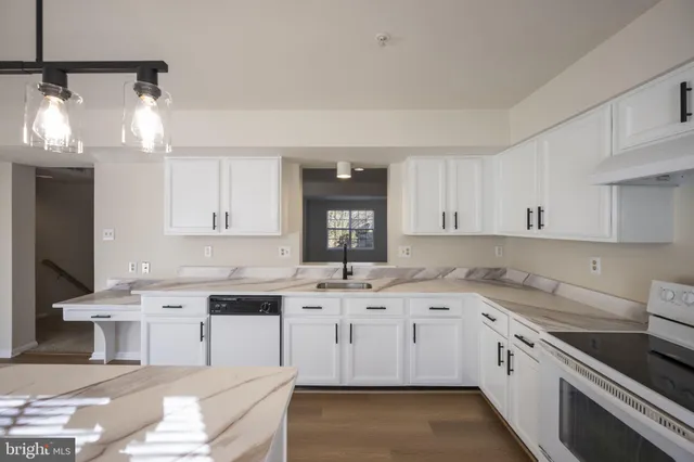 a dining room with furniture and potted plants