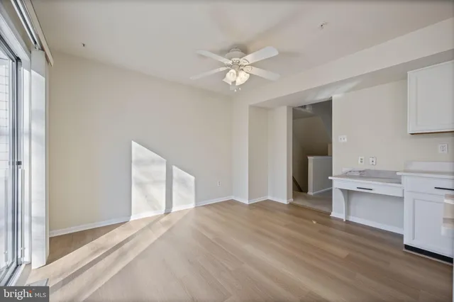 an empty room with a empty space and windows