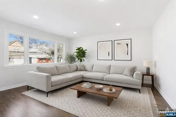 a living room with furniture a rug and a window