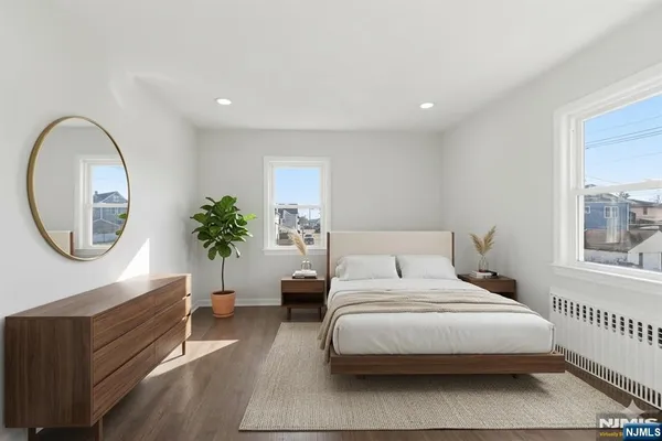 a bedroom with bed and a large window