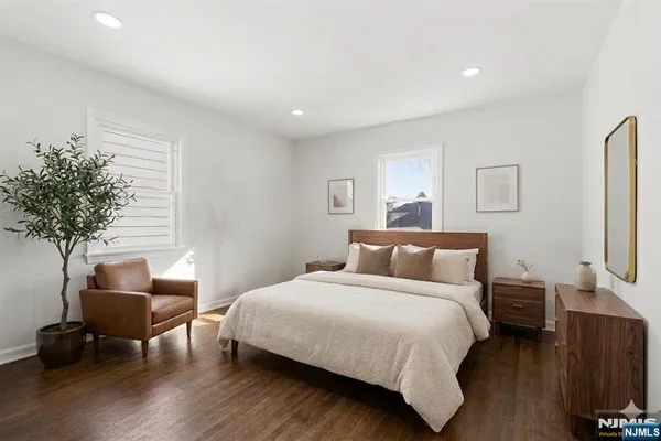 a bedroom with bed and a potted plant