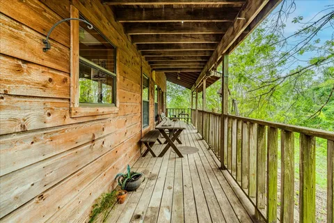 a view of balcony with wooden floor and outdoor seating