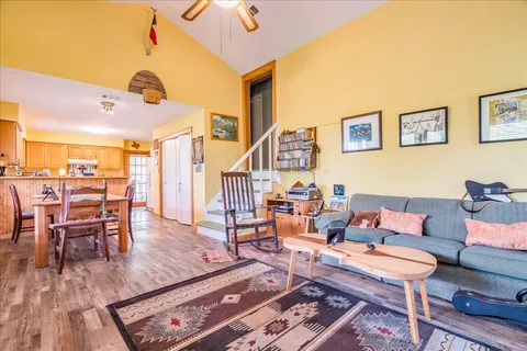 a living room with furniture and wooden floor