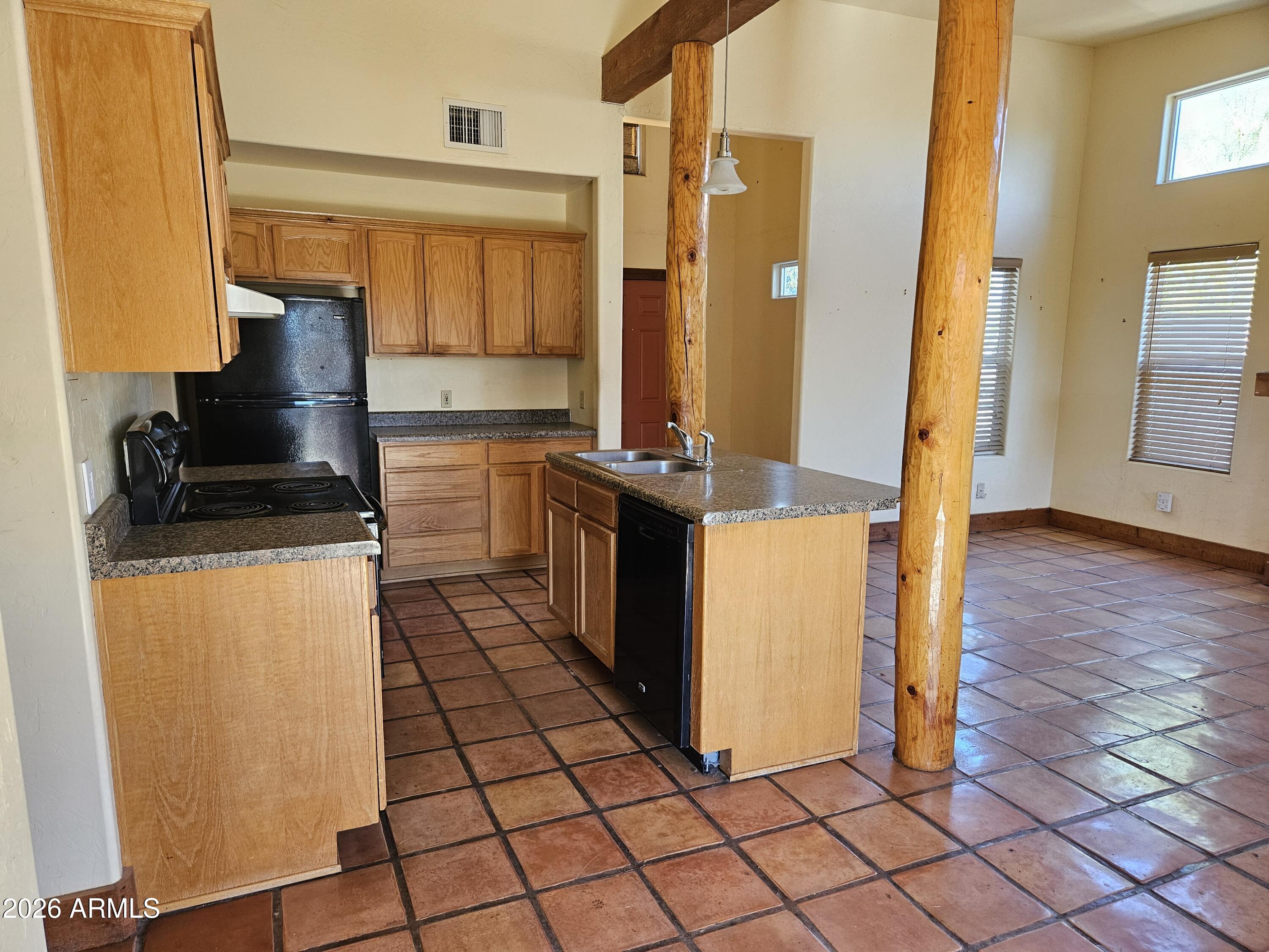 4105 North Washington Avenue Douglas, AZ 85607 - Photo 10 of 61 a kitchen with a sink a stove and cabinets