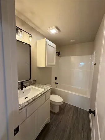 a bathroom with a sink a toilet and bathtub