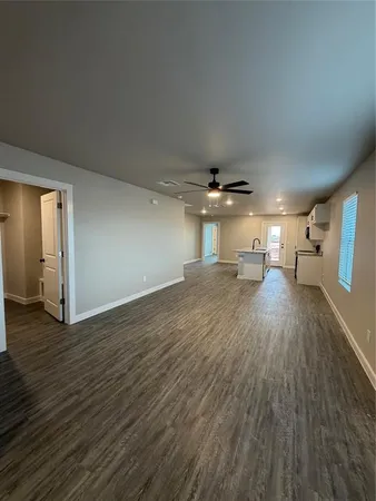 a view of a room with wooden floor