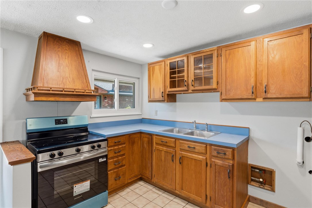 3690 Endover Road Dayton, OH 45439 - Photo 13 of 25 This kitchen offers classic wood cabinetry and a functional layout for everyday living.