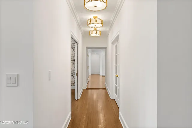 a bedroom with a bed and a flat tv screen on wall