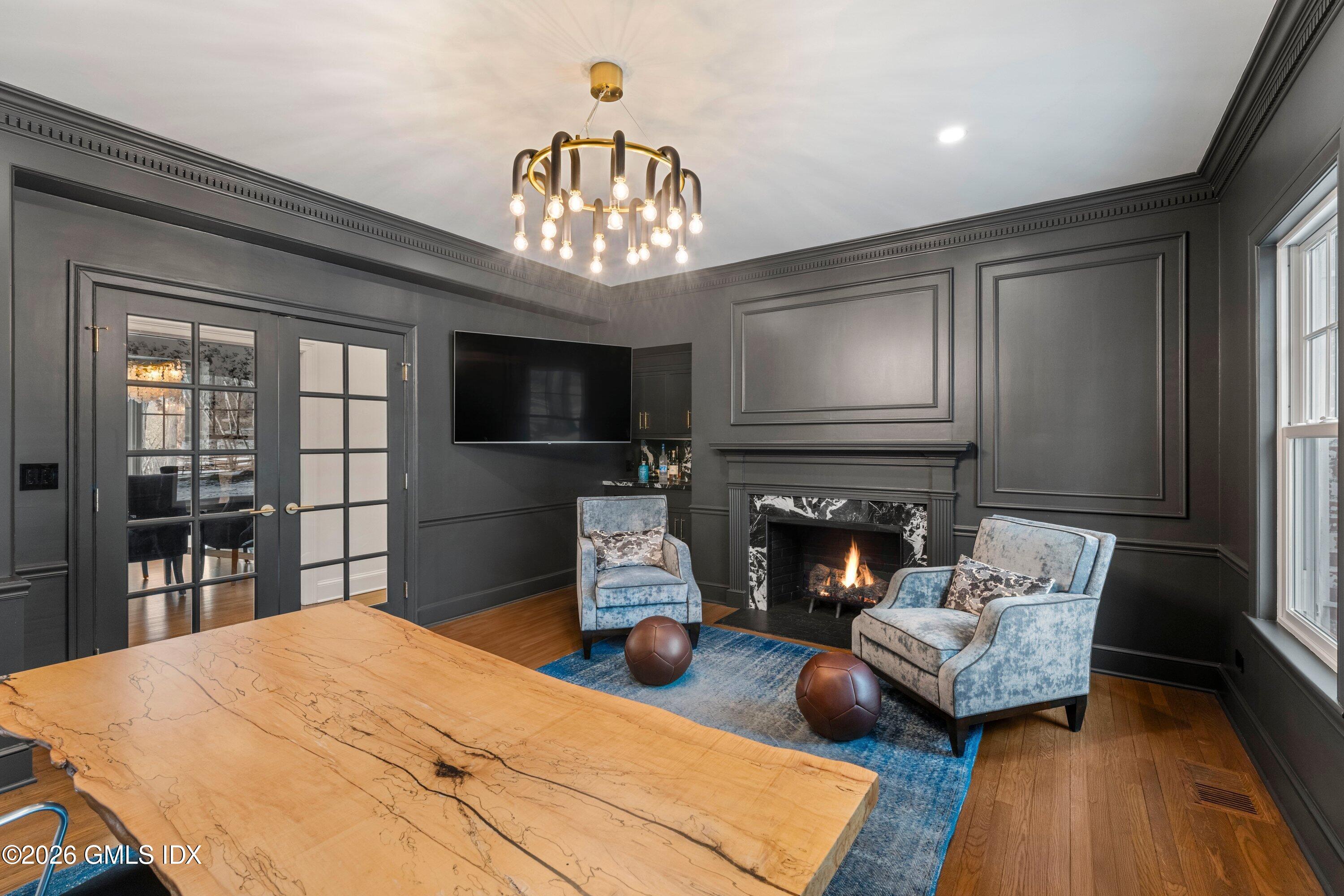 530 Round Hill Road Greenwich, CT 06831 - Photo 19 of 63 a living room with furniture a fireplace and a flat screen tv