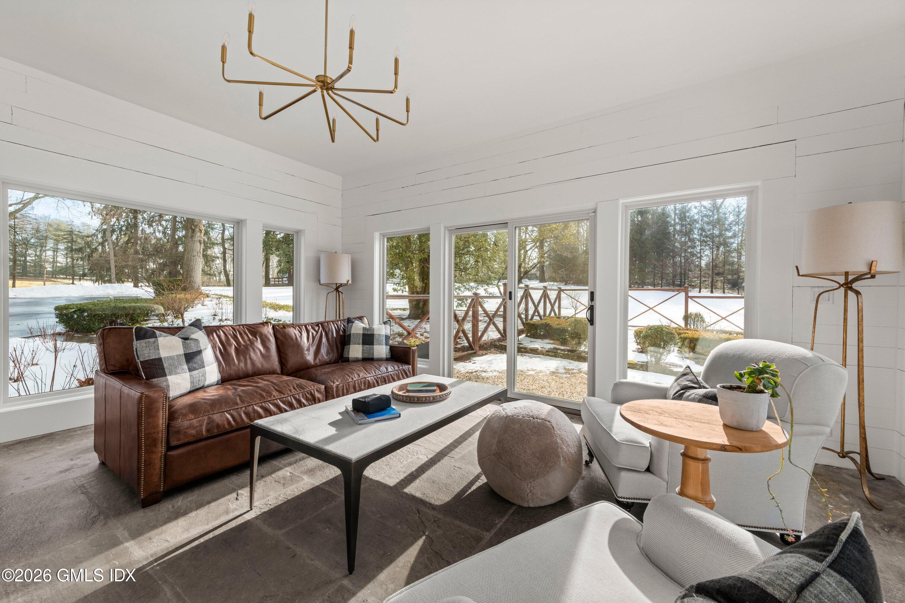 530 Round Hill Road Greenwich, CT 06831 - Photo 20 of 63 a living room with furniture a table and a large window