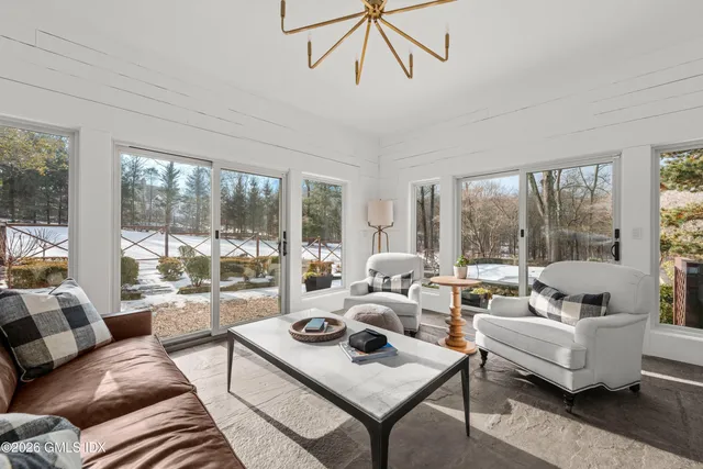 a bedroom with a flat screen tv and a window