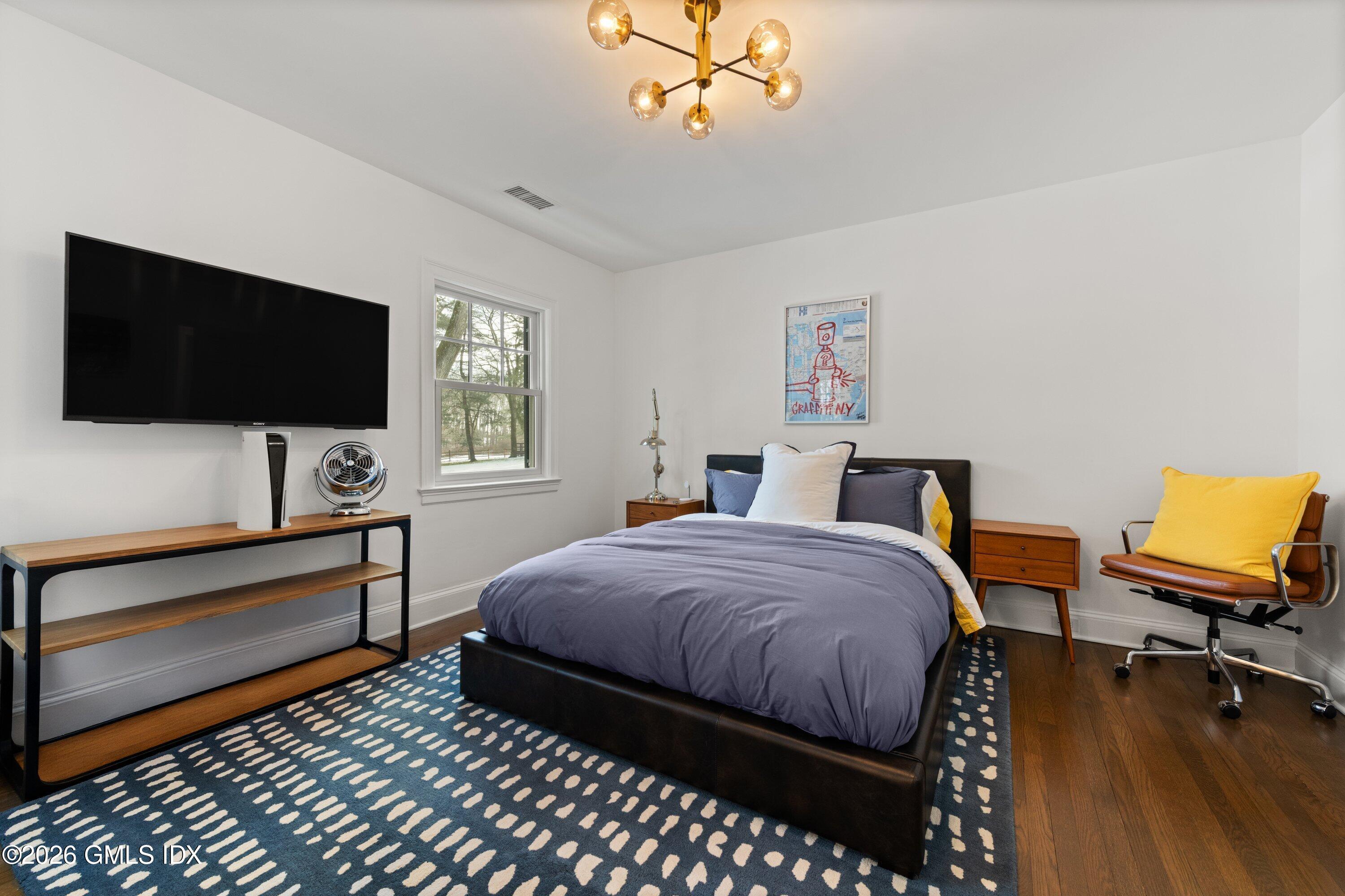 530 Round Hill Road Greenwich, CT 06831 - Photo 34 of 63 a bedroom with a bed and a flat screen tv