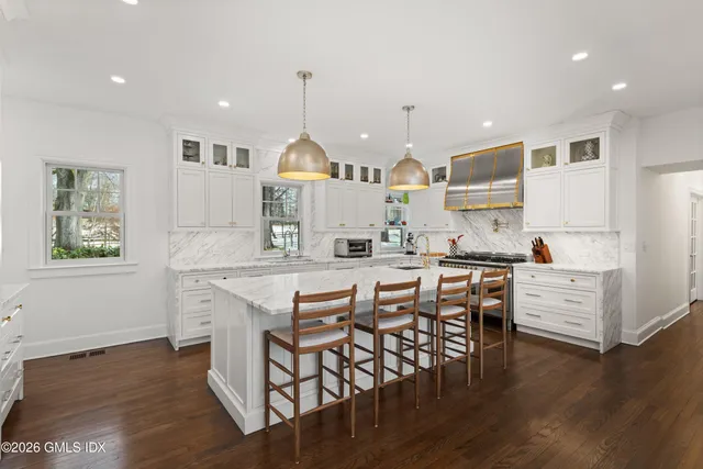 a living room with furniture a table and a large window