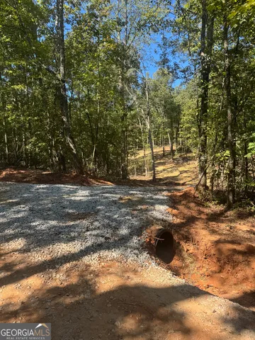 a view of dirt yard with a fountain