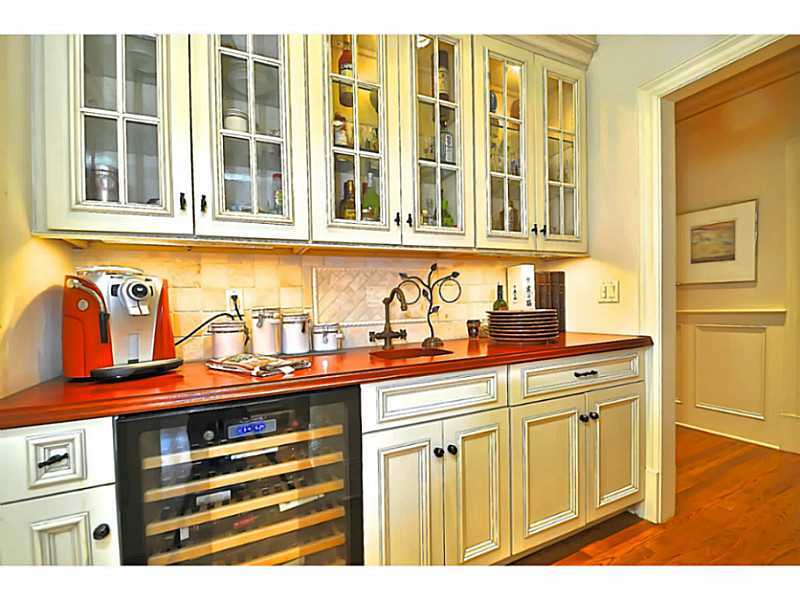 19 Terrace Avenue Riverside, CT 06878 - Photo 5 of 25 a kitchen with stainless steel appliances granite countertop a sink and dishwasher with wooden cabinets