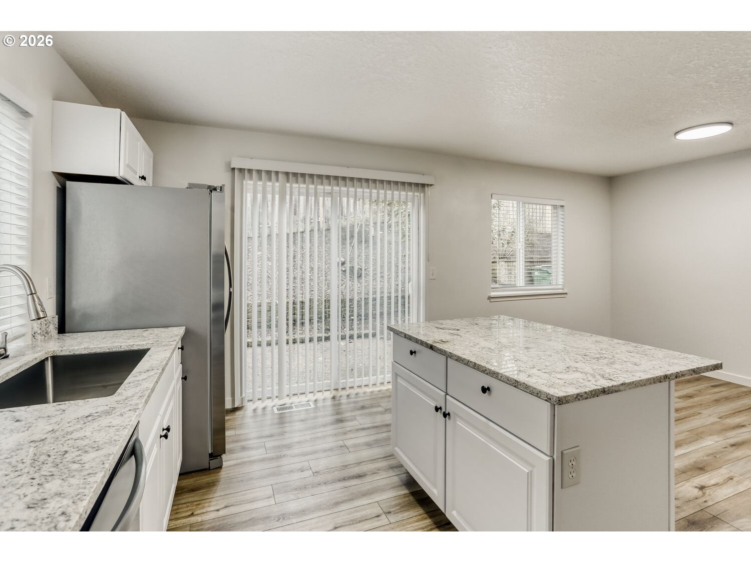 7642 Southwest 205th Terrace Beaverton, OR 97007 - Photo 14 of 28 a kitchen with a sink stove and refrigerator