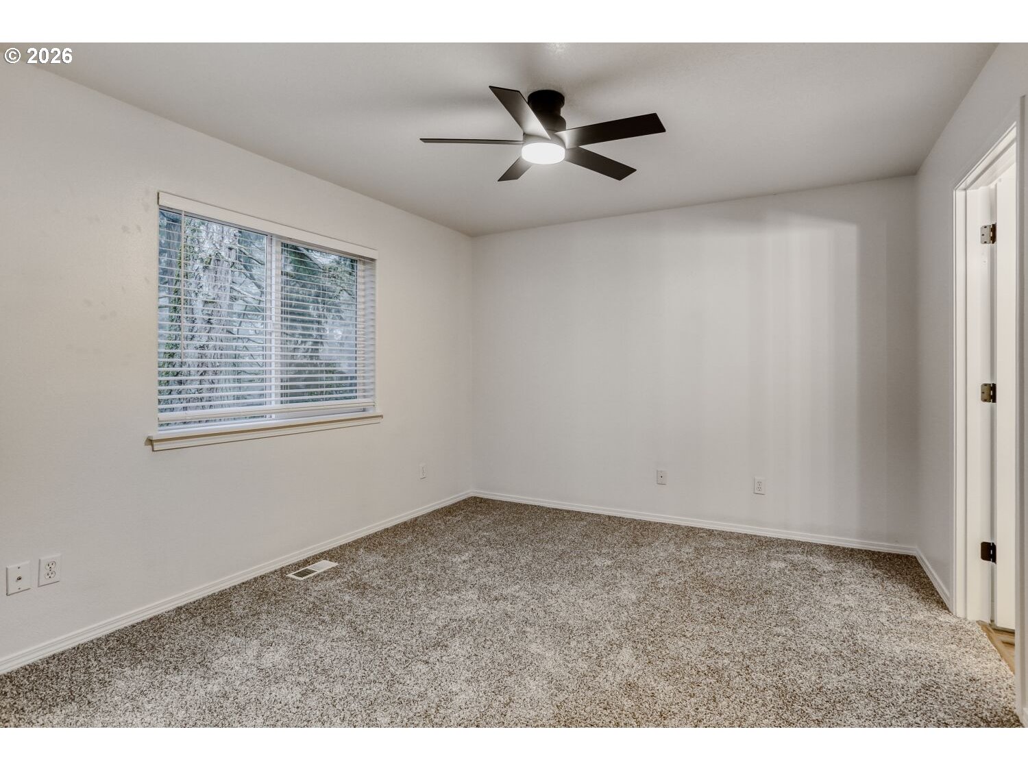 7642 Southwest 205th Terrace Beaverton, OR 97007 - Photo 17 of 28 a view of an empty room with a window