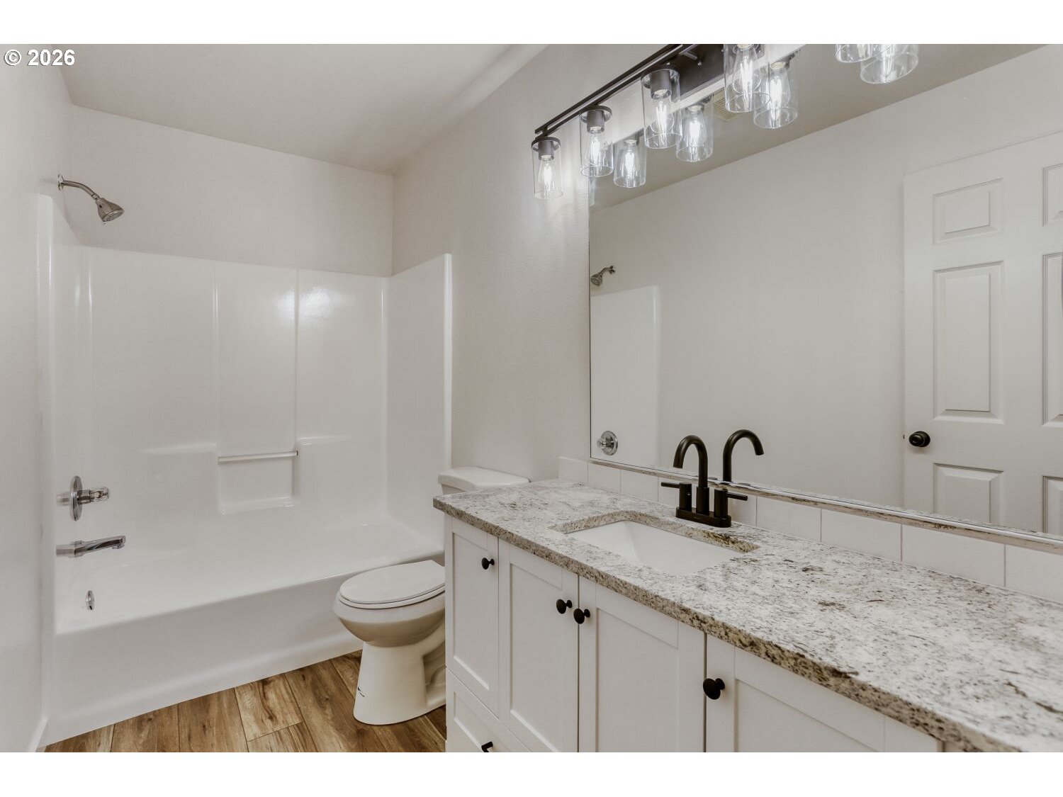 7642 Southwest 205th Terrace Beaverton, OR 97007 - Photo 21 of 28 a bathroom with a granite countertop sink a toilet and a large mirror