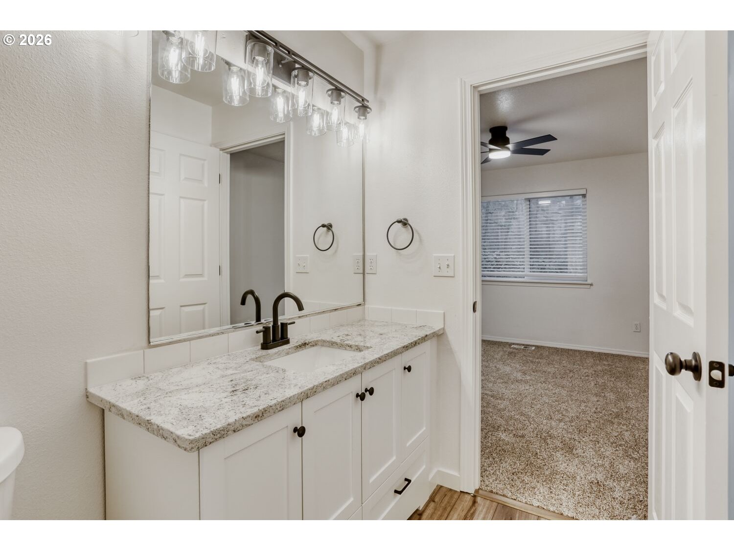 7642 Southwest 205th Terrace Beaverton, OR 97007 - Photo 22 of 28 a bathroom with a granite countertop sink a mirror and shower