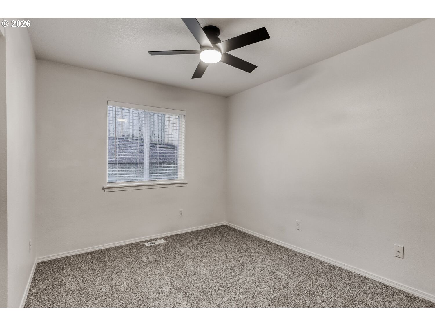 7642 Southwest 205th Terrace Beaverton, OR 97007 - Photo 24 of 28 a view of an empty room with a ceiling fan and window