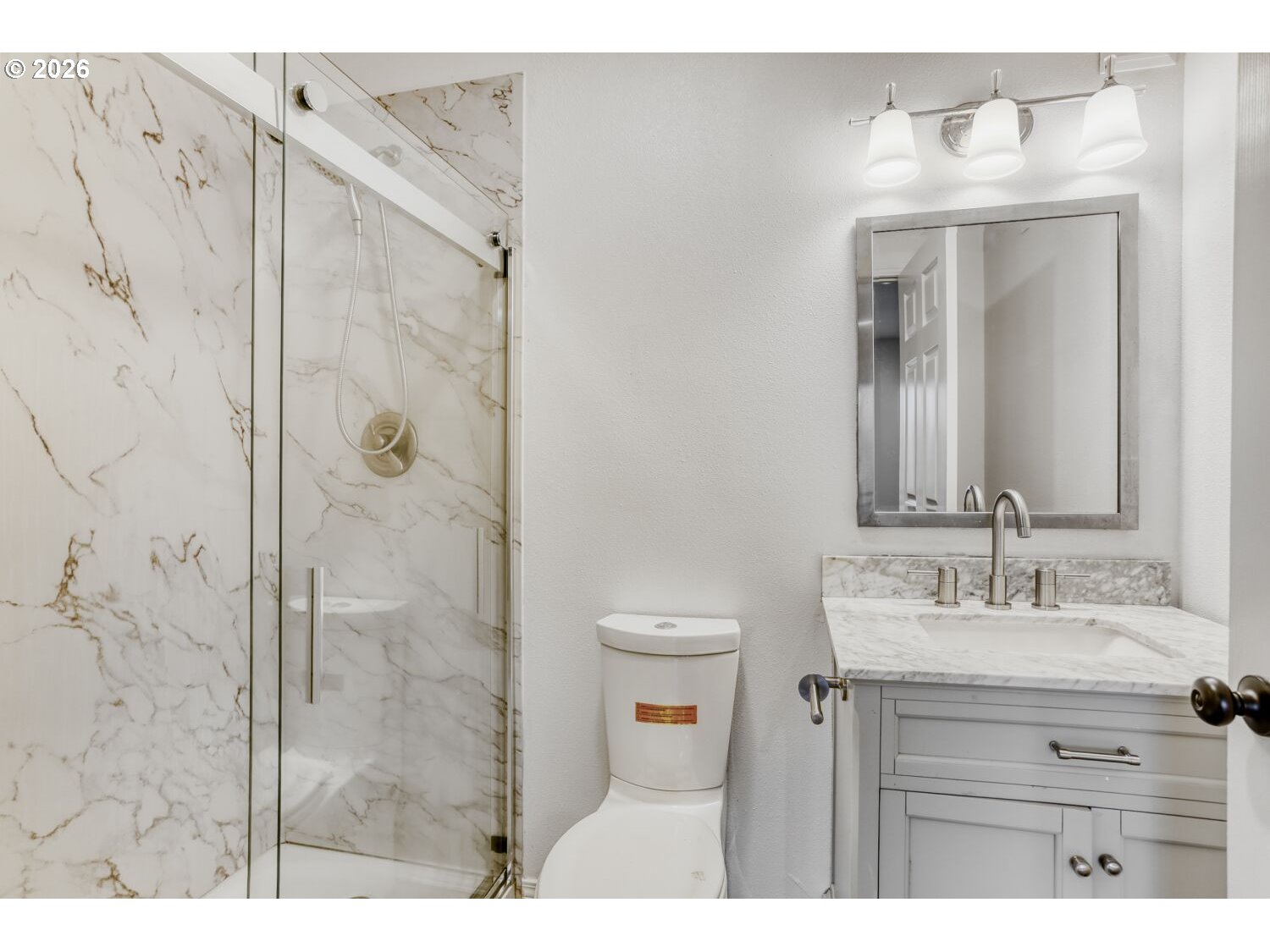 7642 Southwest 205th Terrace Beaverton, OR 97007 - Photo 26 of 28 a bathroom with a sink vanity granite shower and a mirror