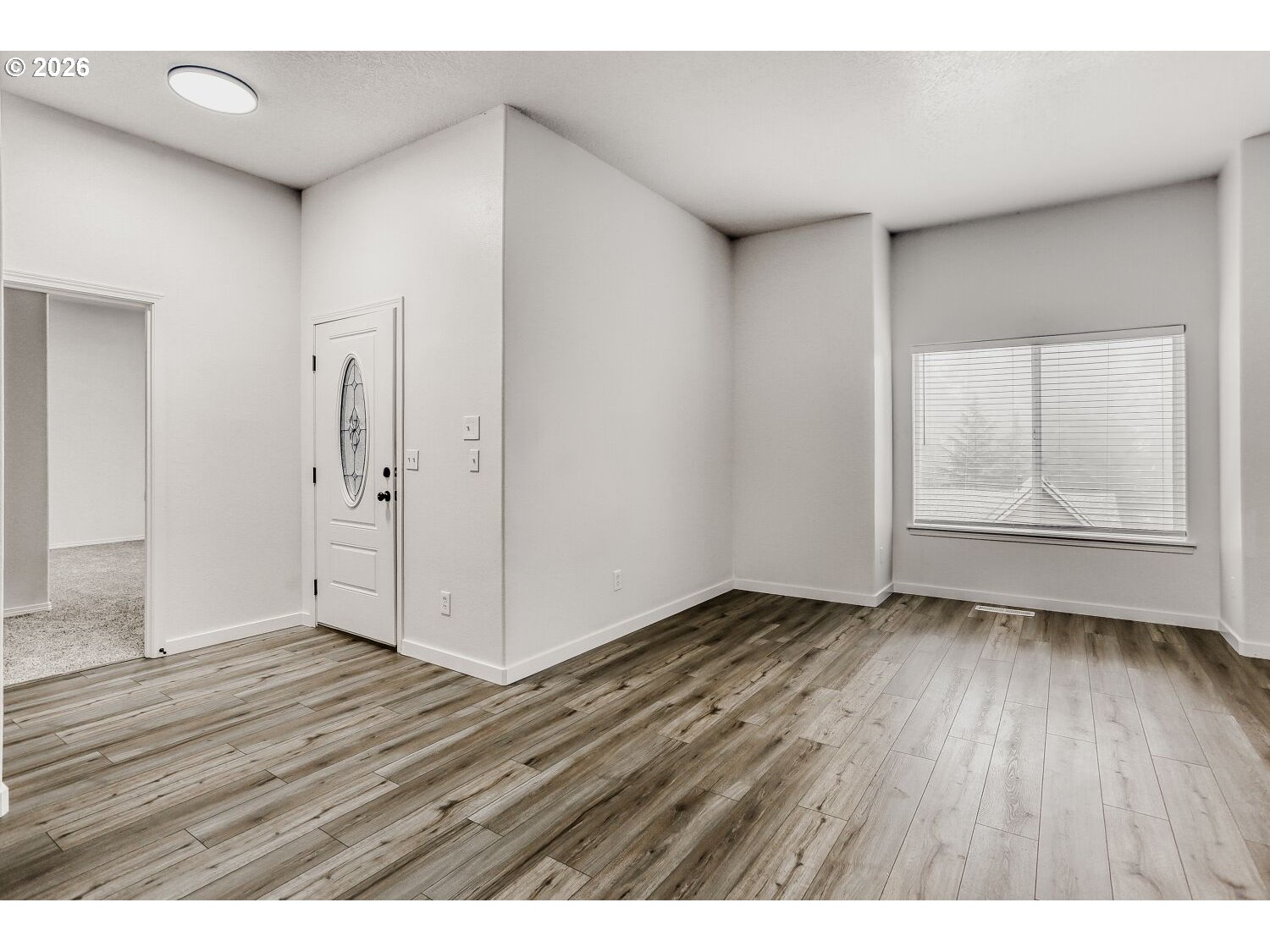 7642 Southwest 205th Terrace Beaverton, OR 97007 - Photo 7 of 28 a view of an empty room with wooden floor