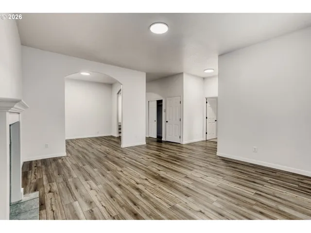 a view of an empty room and wooden floor