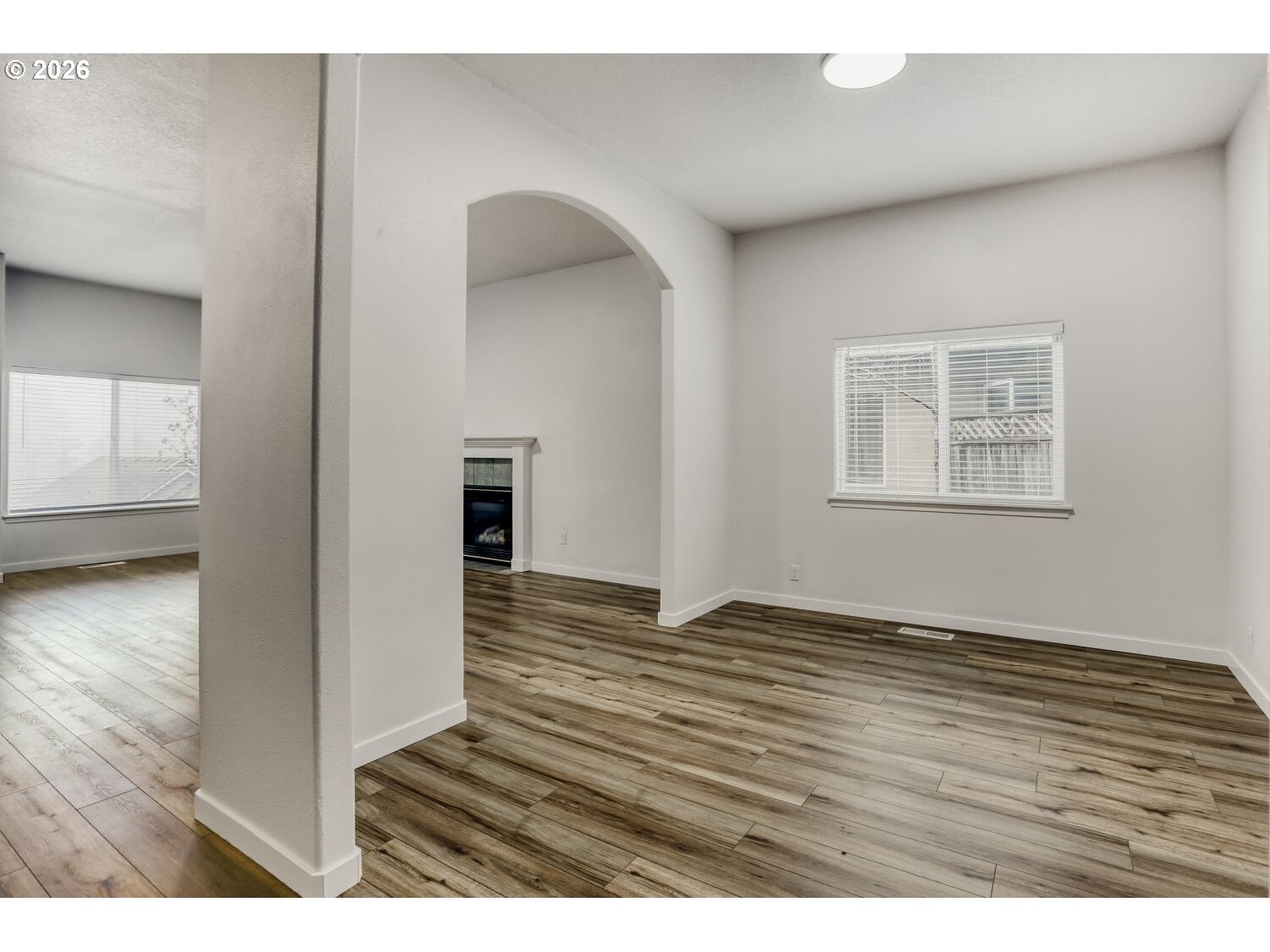 7642 Southwest 205th Terrace Beaverton, OR 97007 - Photo 9 of 28 a view of an empty room with wooden floor and a window