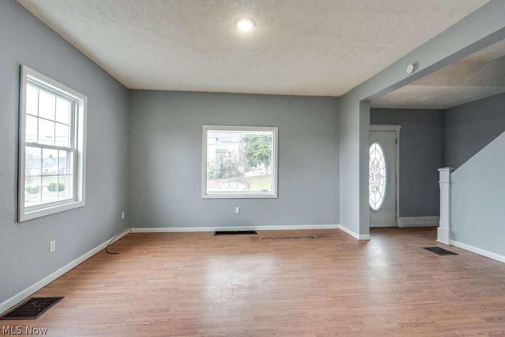 1607 9th Street Southwest Canton, OH 44706 - Photo 11 of 41 Spacious room featuring wood-finish flooring, two large windows, and a recessed ceiling light
