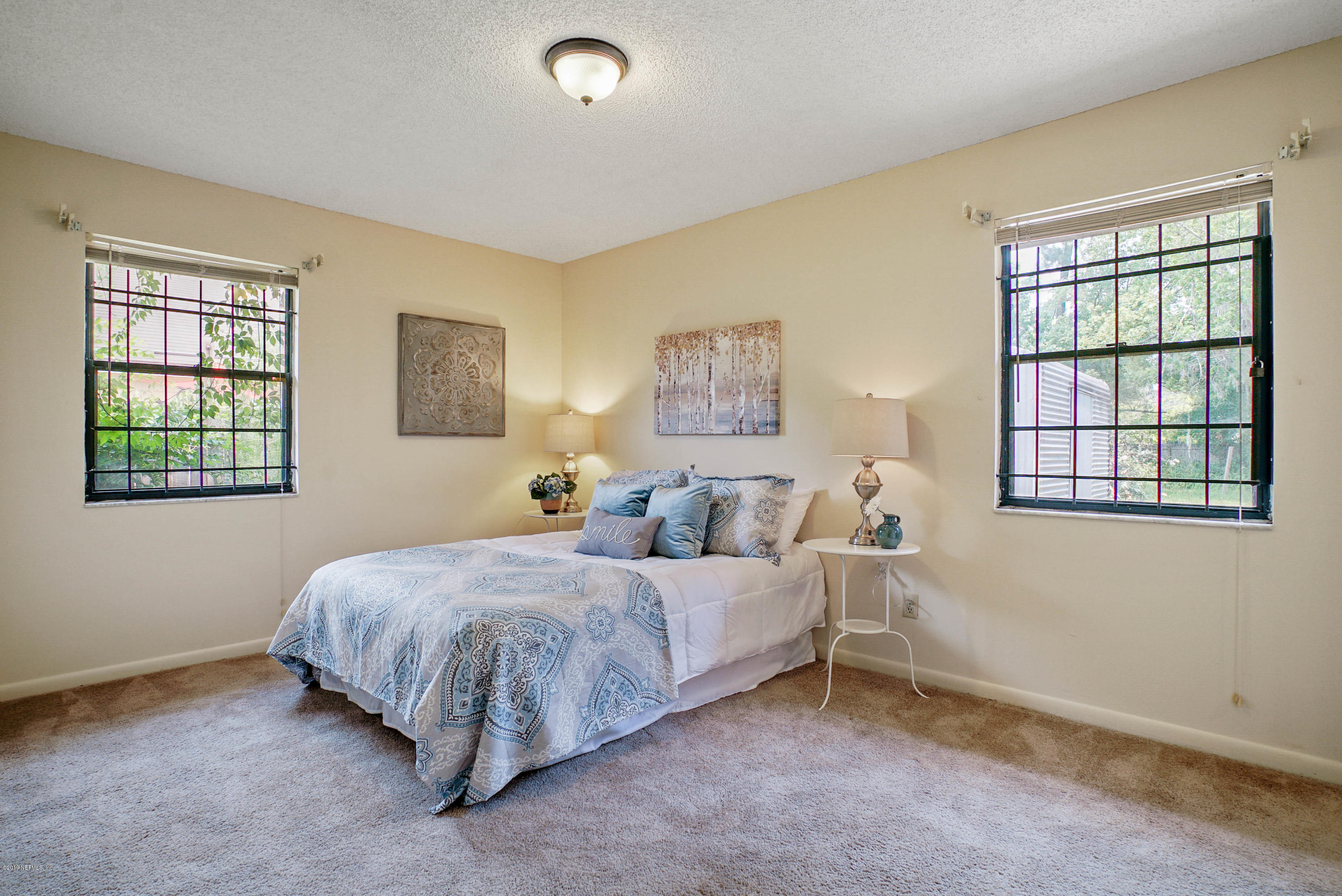 5353 Hickson Road Jacksonville, FL 32207 - Photo 11 of 18 a bedroom with a bed and a window