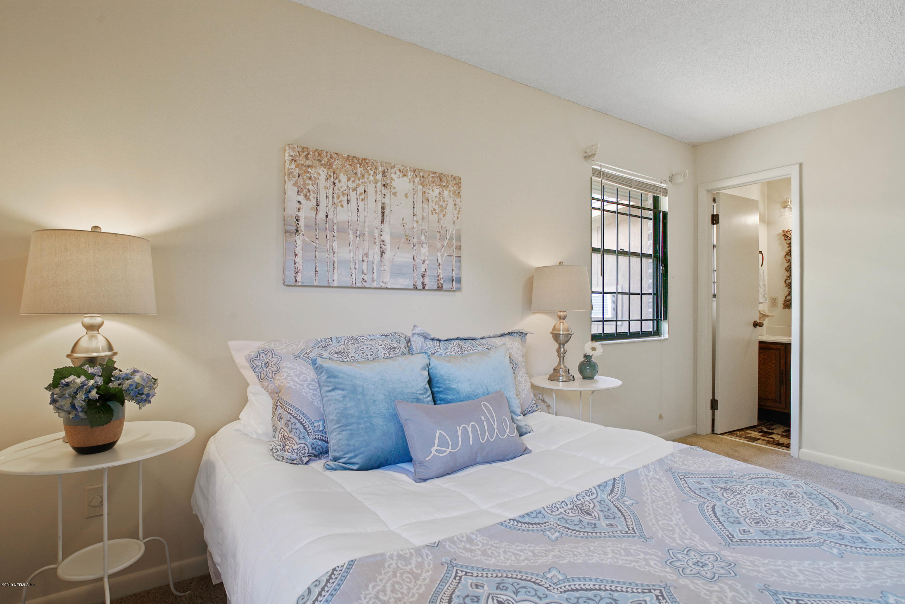 5353 Hickson Road Jacksonville, FL 32207 - Photo 12 of 18 a bed room with a bed and a painting