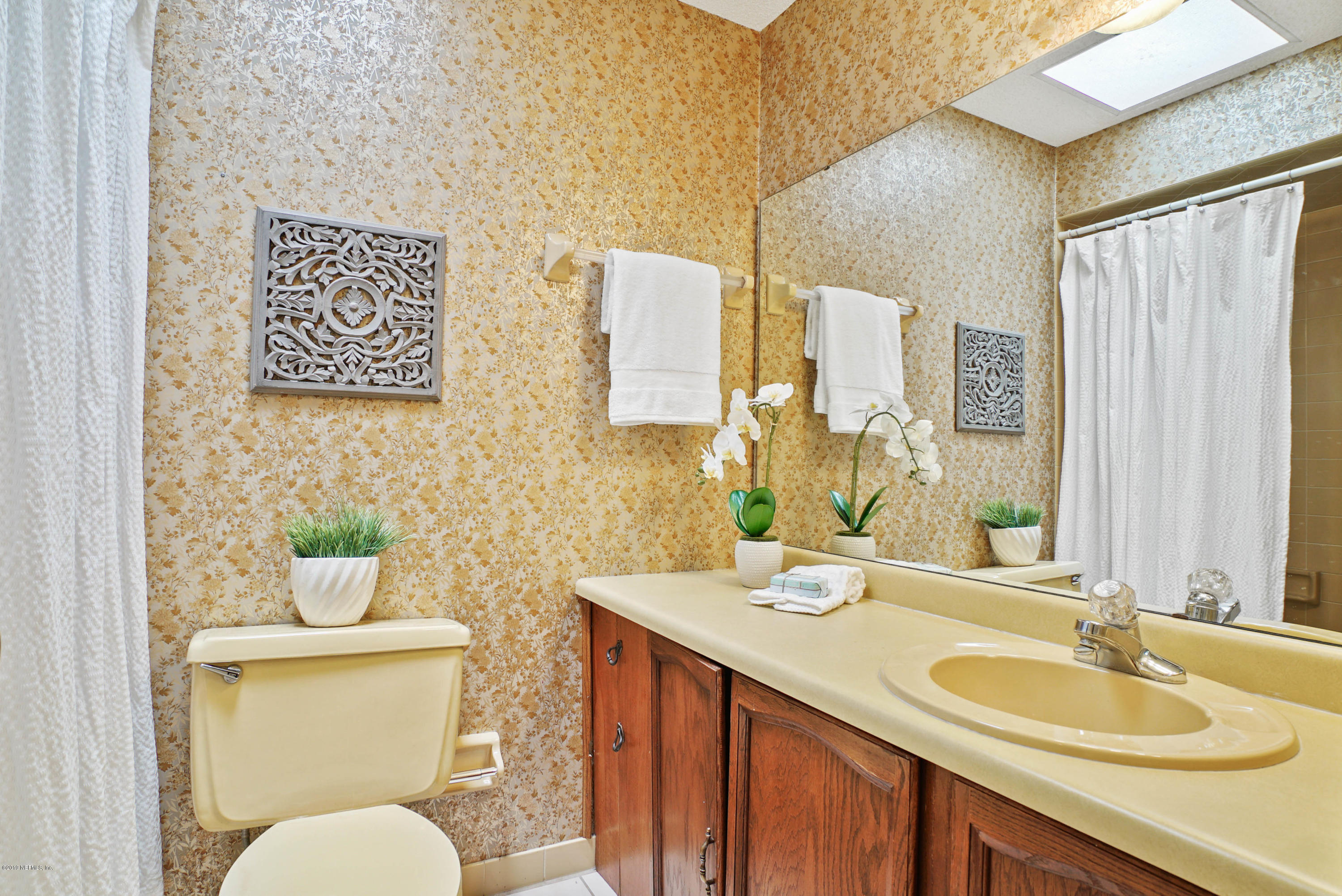 5353 Hickson Road Jacksonville, FL 32207 - Photo 15 of 18 a bathroom with a granite countertop sink toilet and a mirror