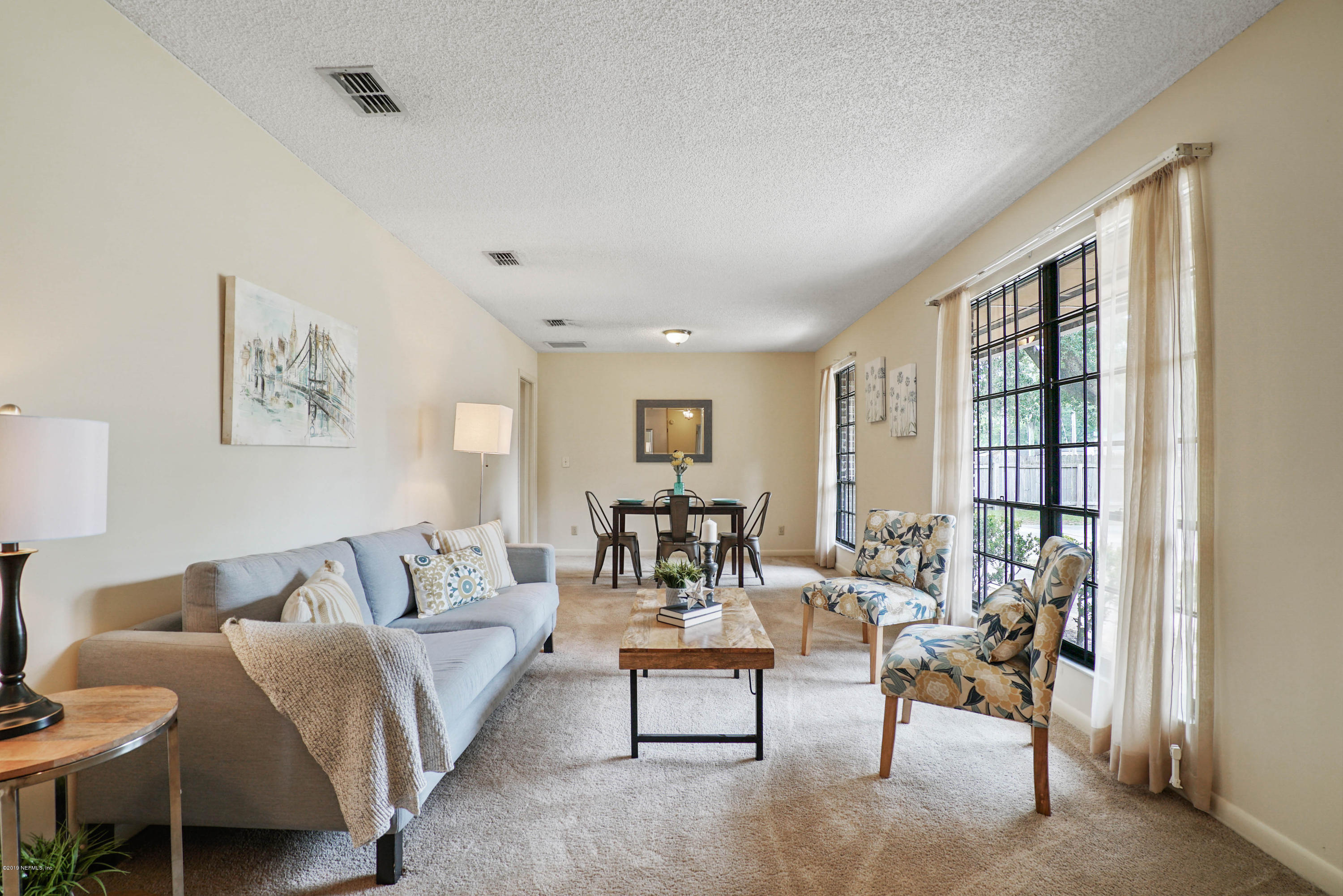 5353 Hickson Road Jacksonville, FL 32207 - Photo 4 of 18 a living room with furniture and a large window