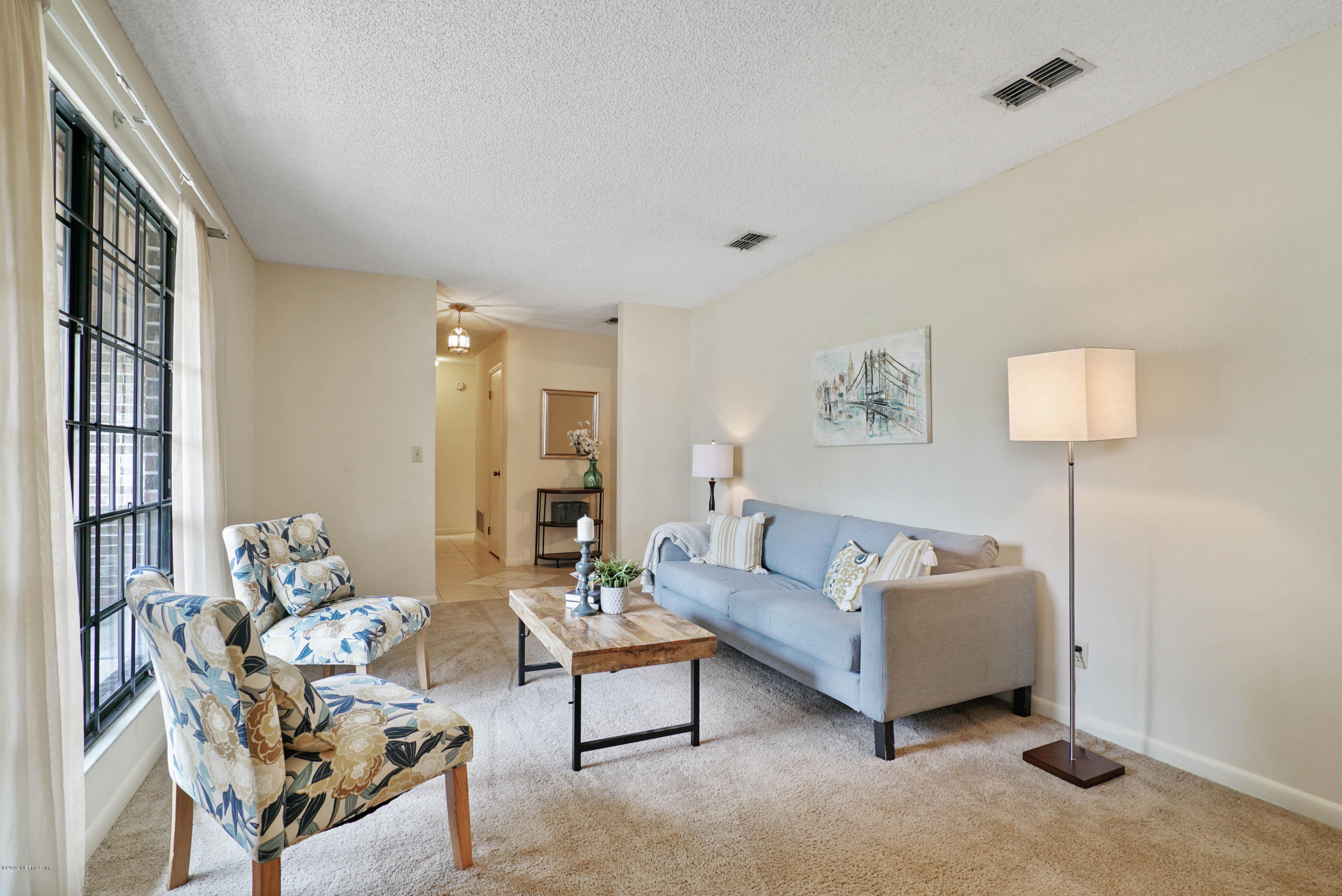 5353 Hickson Road Jacksonville, FL 32207 - Photo 5 of 18 a living room with furniture and a lamp